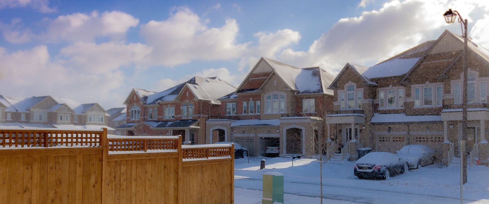 Snowy suburban street with two-storey homes after a fresh snowfall