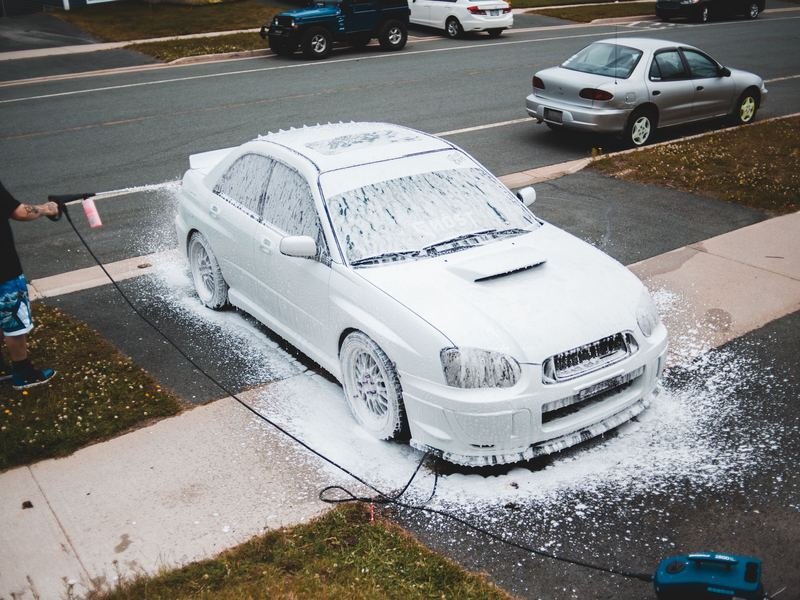Car covered in foam during a driveway wash